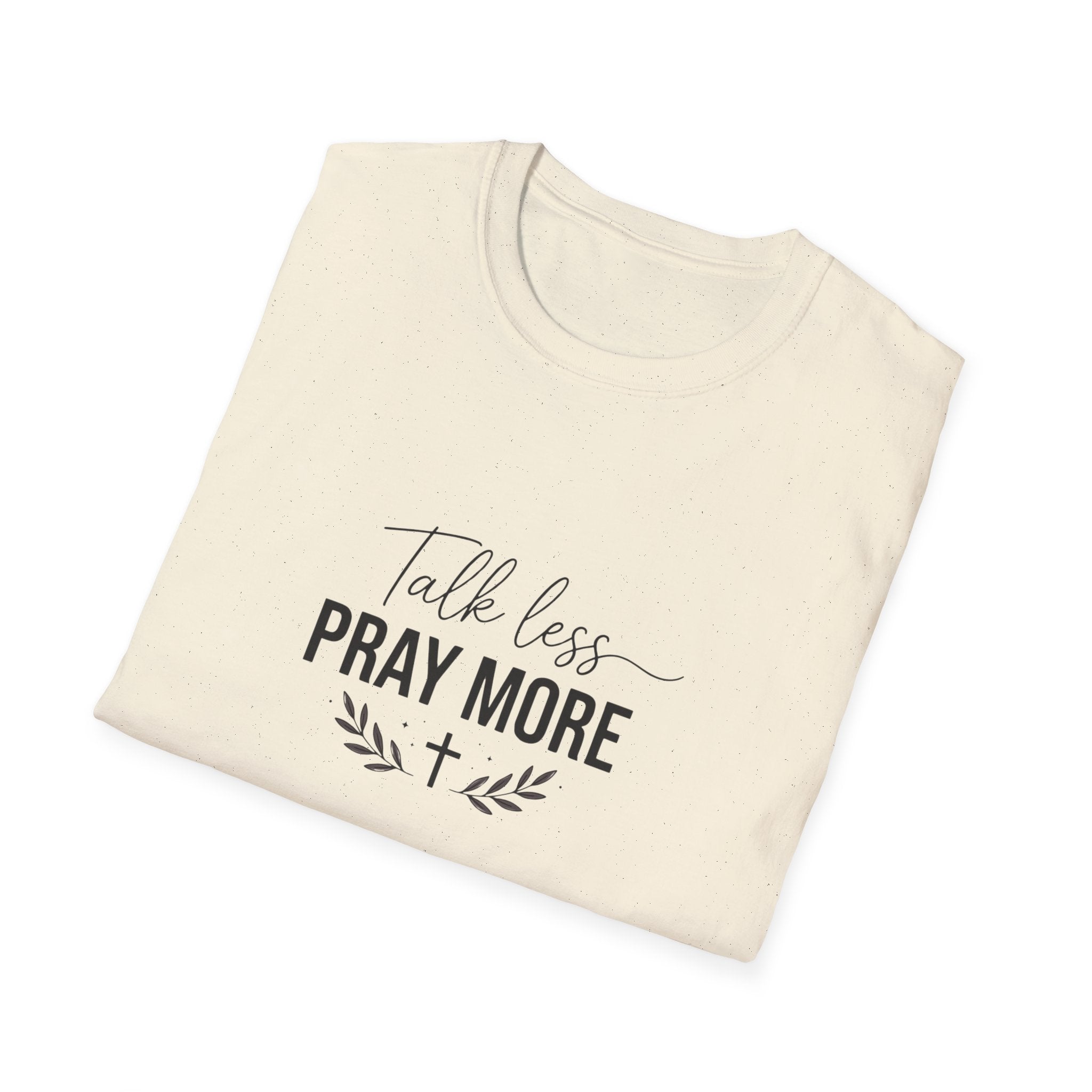Folded beige t-shirt with 'Talk less, Pray more' text on a white background